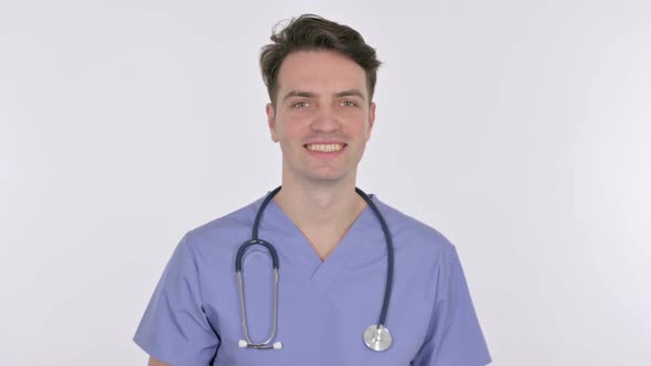 Young Doctor Smiling at Camera on White Background