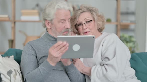 Online Video Call on Tablet By Old Couple at Home