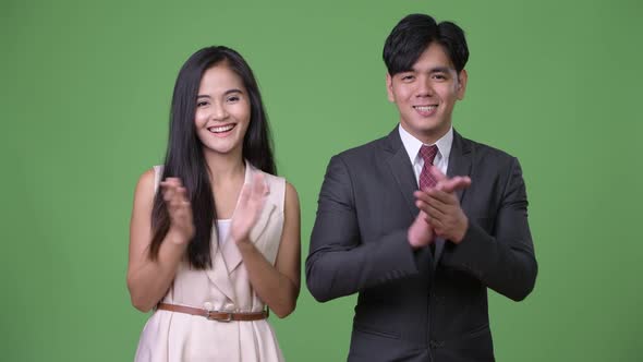 Young Asian Business Couple Clapping Hands Together