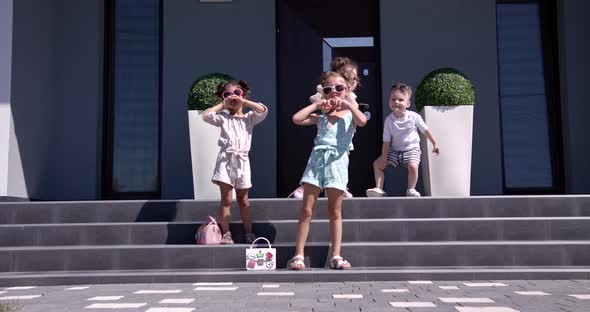 Young Children Run Around Playing In Front Of The House