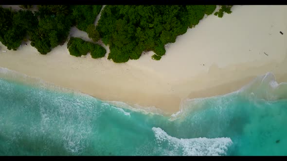 Aerial top down abstract of perfect shore beach holiday by shallow water and white sandy background 