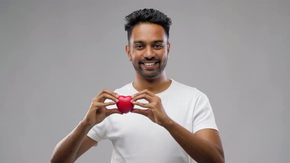 Indian Man with Red Heart Over Grey Background 40