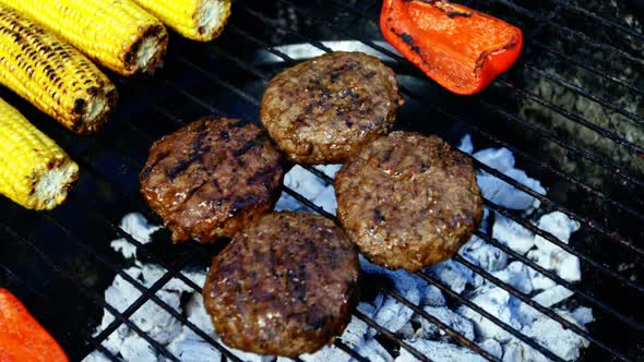 Grilling meat and vegetables on barbecue