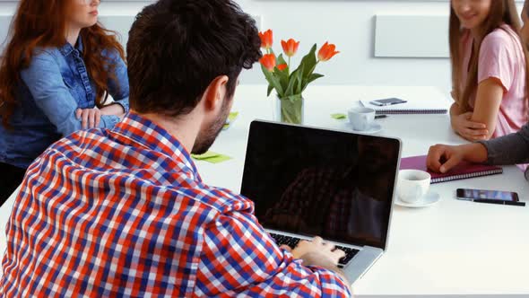 Portrait of male business executive using laptop