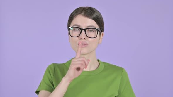 Beautiful Woman Putting Finger on Lips on  Pink Background