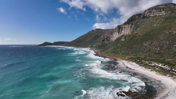 Unspoilt sandy beach at Misty Cliffs, jagged Cape Peninsula coastline; aerial