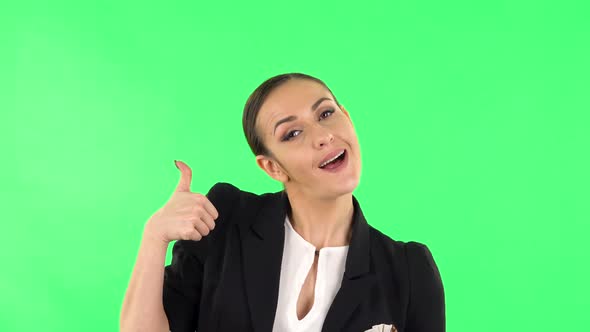 Young Cheerful Woman Showing Thumbs Up, Gesture Like. Green Screen