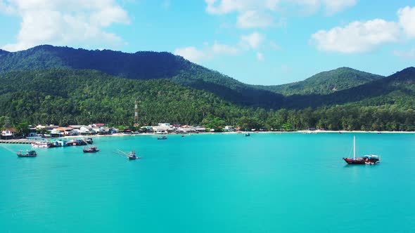 Daytime overhead abstract view of a white sand paradise beach and turquoise sea background in colorf