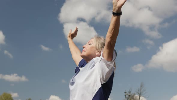 Active Mature Senior Woman Doing Sports Cool Down Take Deep Breath Hands Up