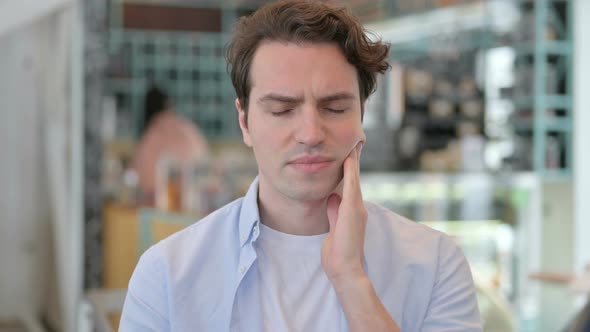 Portrait of Attractive Young Man Having Toothache Cavity