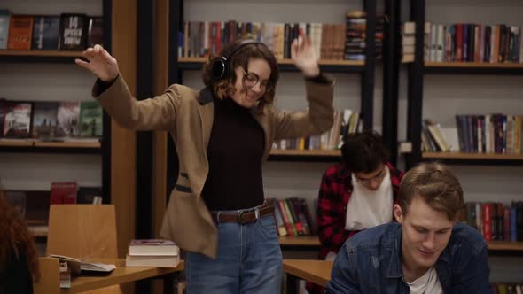 Joyful Excited European Woman in Jacket and Jeans Performing Expressive Dance While Listening Groovy