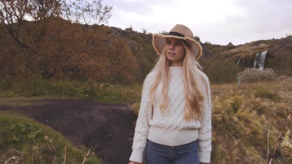 Blond Woman Walking In Icelandic Countryside