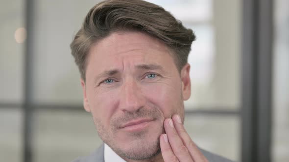 Close up of Middle Aged Man with Toothache