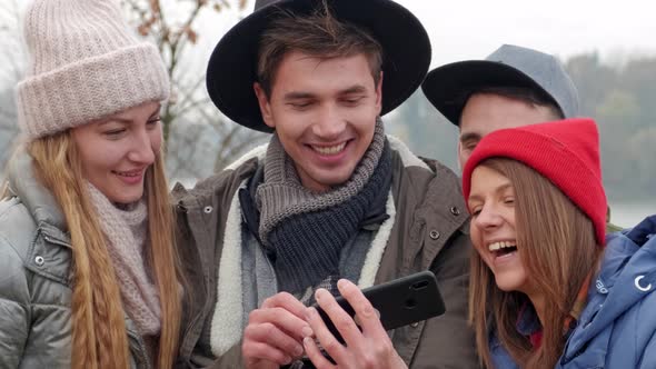 Happy Group of Tourists Traveling and Sightseeing Using Phone.