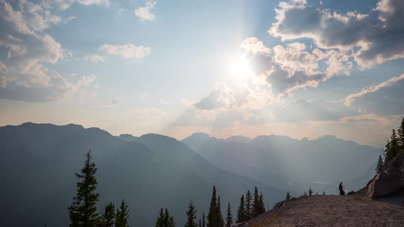 Timelapse of the sun shining over mountains