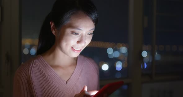 Young Woman Check on Mobile Phone at Night