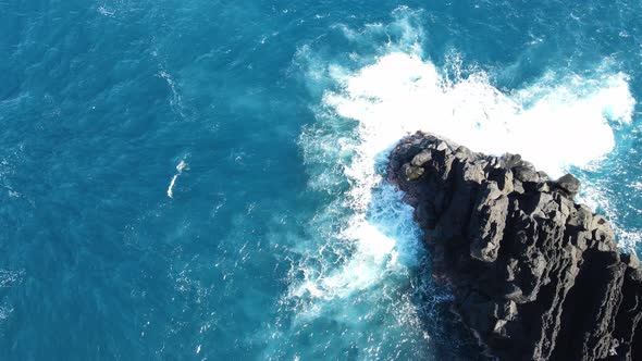 Top-down drone footage of waves and rocks at the Cap Mechant on the Reunion island.