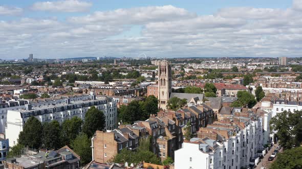 Slide and Pan Footage of Church Tower Above Houses in Urban Neighbourhood