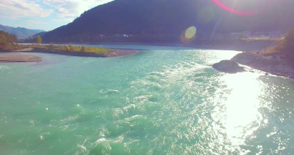 Low Altitude Flight Over Fresh Fast Mountain River with Rocks at Sunny Summer Morning.