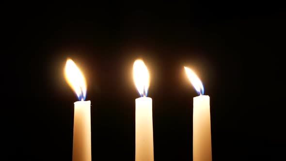 Three White Candles Burn In The Dark