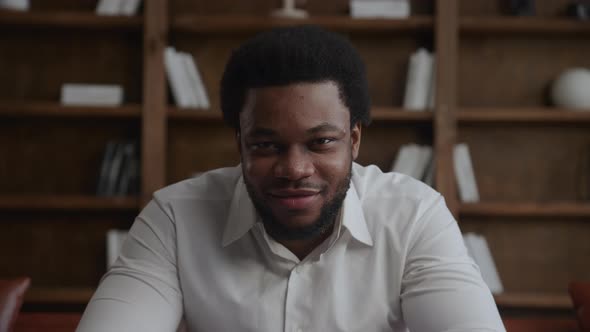 Young Adult African American Businessman Raising His Head Up and Looking at Camera