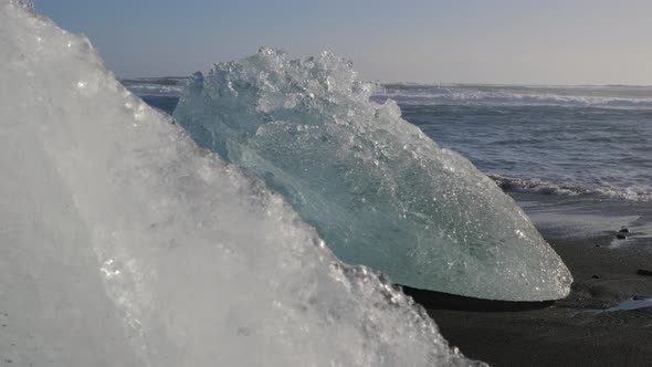 Iceland Jokulsarlon Diamond Beach With Iceberg Ice Chunks On Black Sand Ocean Shoreline