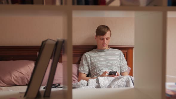 Man On The Bed With Phone