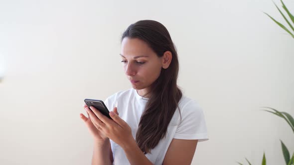 Young Caucasian Woman with Phone. Censorship in Internet. 