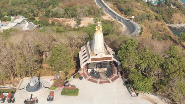 Temple Light House next to Promthep Cape in Phuket, Thailand - Aerial Ascending Dronie survey shot 