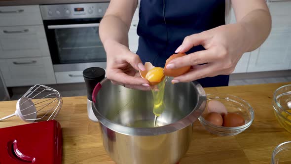 Chef Cracking an Egg in a Bowl and Separates the Yolk From the Protein
