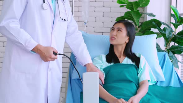 Doctor in Professional Uniform Examining Patient at Hospital