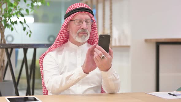 Senior Old Arab Businessman Using Smartphone