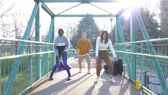 Three people dancing Hip-Hop on a bridge