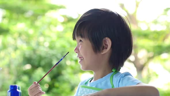 Close Up Of Asian Child Painting His Face