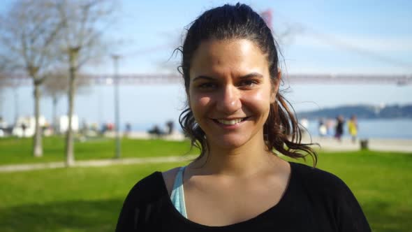 Portrait of Sportive Young Woman Smiling at Camera Outdoor