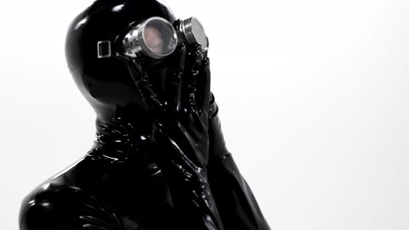 Portrait of a Woman Dressed in a Tight Black Latex Suit for a BDSM Roleplaying Game on Her Face She