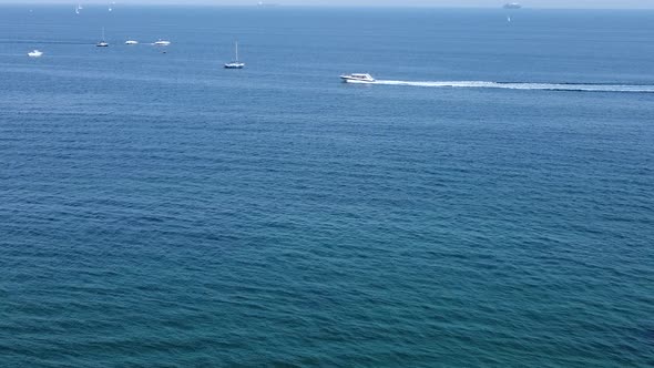 Blue sea, yachts, boats and ships float on the water. Aerial view of a drone near the port