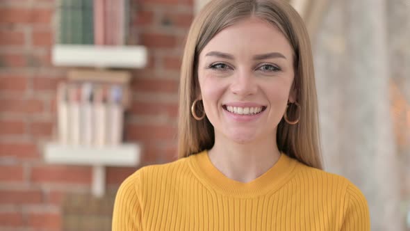 Portrait of Beautiful Young Woman Smiling at the Camera