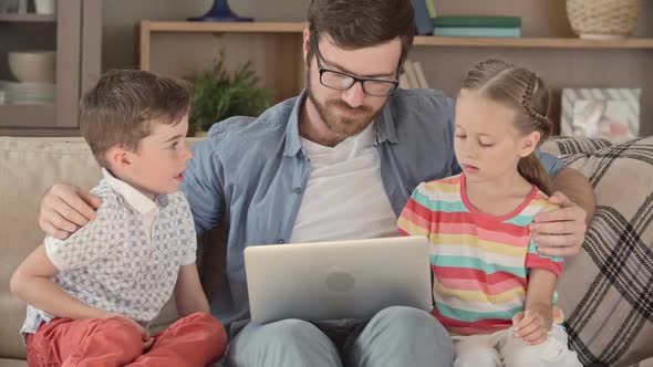 Dad and Kids Using Laptop