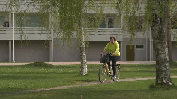 Beautiful Shot of a Middle Aged Lady Riding a Bicycle in Helsinki Finland