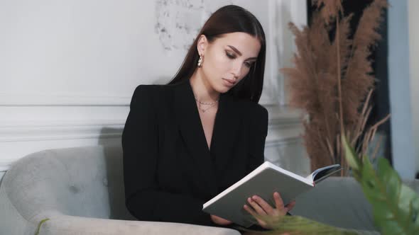 Stylish Cute Young Caucasian Woman Is Reading Book 