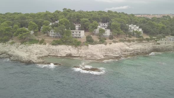 Rocky Shore With Apartments During The Storm. Aerial View From The Seaside. Flat Color