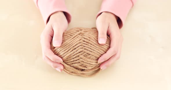 Woman hand holding knit wool ball