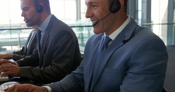 Business people wearing headsets in a modern office