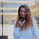Girl is Talking on Phone on Street in City and is Reflected in Glass - VideoHive Item for Sale