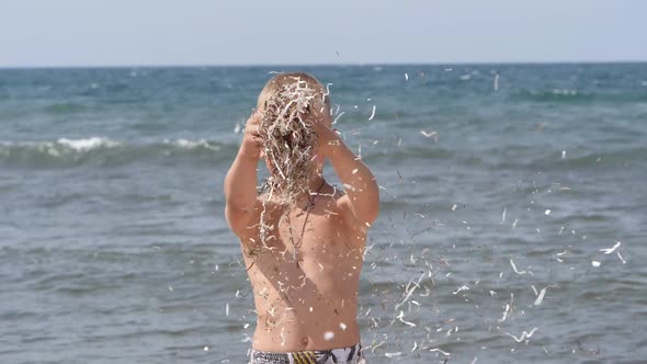 Beach Summer Vacation. Children's Emotions. The Child Develops Tinsel in the Wind