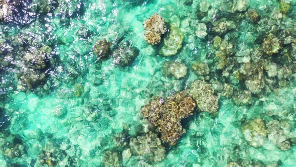 Beautiful birds eye island view of a white sand paradise beach and blue ocean background in colorful