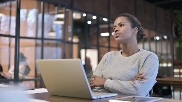 Positive African Woman Sitting at Work