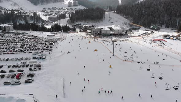 Aerial View on Lot of People Skiing on Ski Slopes Near Ski Lifts on Ski Resort