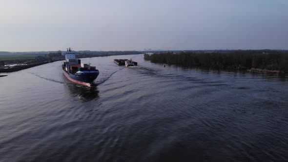 Container Ship Of Pachuca On The Oude Maas River With A View Of Green Woods In Netherlands. aerial